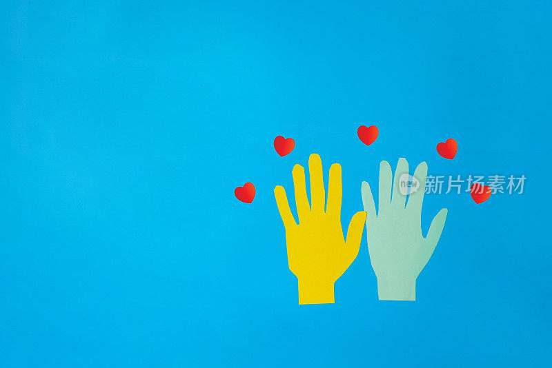 The heart is the symbol of love concept. Valentine day is the day of love or romantic day. All people have heart and love. A small red heart is on the blue, pink and light green hand heart shape.